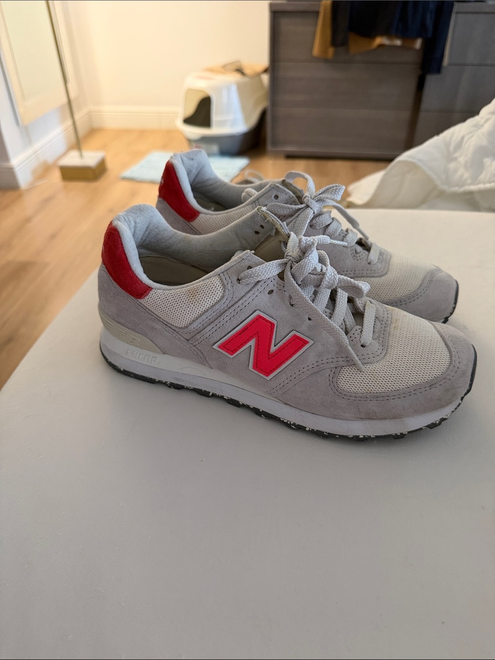 New Balance Light Gray Sneakers with Red Logo Accents